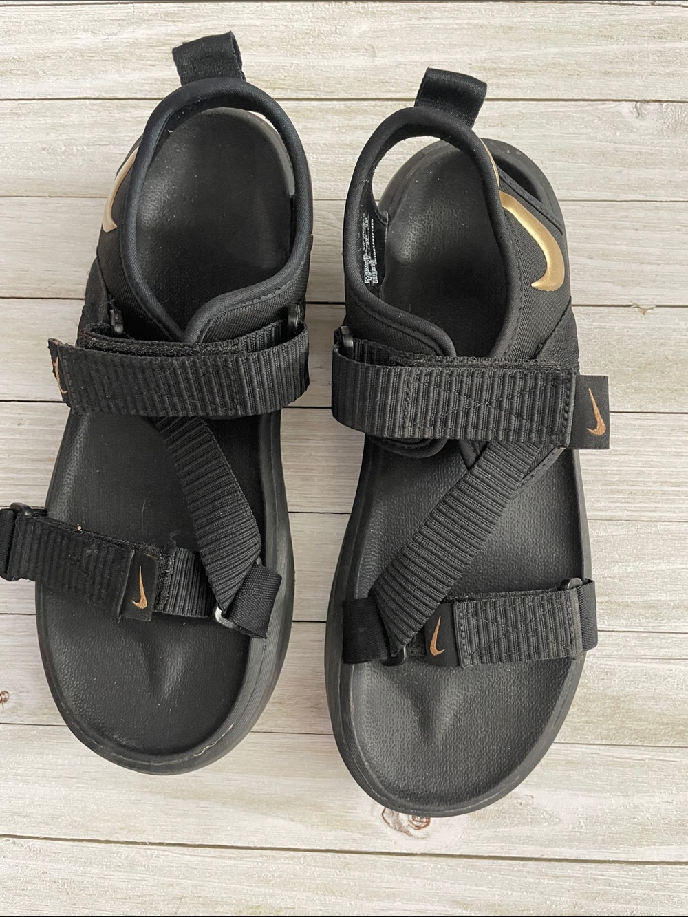 Nike Black Sandals with Gold Swoosh Detailing